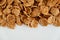 Crispy healthy dry cereal flakes on white background