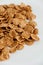 Crispy healthy dry cereal flakes on white background