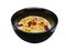 Crispy and healthy organic breakfast cereal flakes with red dried cranberry and cold soy milk in dark black handmade pottery bowl