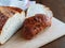 Crispy heel of an artisan potato bread loaf on wooden board