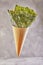 Crispy nori seaweed in a cone cup on a gray background. Japanese food nori. Dried sheets of seaweed