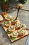 Crispy open-face sandwiches with mutabal topping on the cutting