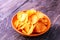 Crispy potato chips in a bowl. Tasty paprika chips