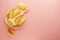 Crispy potato chips isolated over pink background. Top view. Copy space