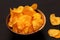 Crispy potato chips with paprika wooden bowl. Unhealthy vegan fast food. Top view. Copy space