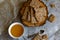 Crispy rectangular crispbreads with sesame seeds and seeds with natural honey in an interestingly decorated composition with wood