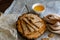 Crispy rectangular crispbreads with sesame seeds and seeds with natural honey in an interestingly decorated composition with wood