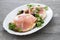 Crispy rice diet toasts with prosciutto on ceramic background