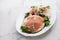 Crispy rice diet toasts with prosciutto on ceramic background