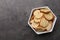 Crispy rusks in bowl on grey table, top view. Space for text