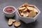 Crispy rusks and dip sauce on grey table, closeup