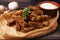 Crispy rusks with rosemary and sauce on wooden table, closeup