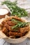 Crispy rusks with rosemary on white table, above view