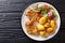 Crispy steaks in sesame breading with new potatoes and fresh salad close-up on a plate. horizontal top view