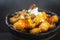 Crispy tater tots doused mercilessly in spicy jalapeno cheese sauce, maple-glazed bacon and sour cream.  Finished with a splash of