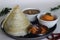 Crispy thin ghee dosa with sambar, coconut chutney and Molaha Podi. Dosa is served in tent shape. A South Indian breakfast