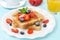 Crispy toast with honey and fresh berries for breakfast
