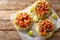 Crispy tostadas topped with guacamole, spiced shrimp, and fresh salsa closeup on the table. Horizontal top view