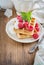 Crispy wafers with cream and fresh raspberries for