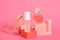 cristal glass perfume bottles and podiums on pink background copy space