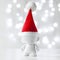 Cristmas toy in Red Hat Santa Claus, Symbol New Year, Defocused Lights White Background