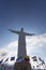 Cristo del Rey statue of Cali with world flags and blue sky, Col