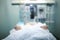 Critically ill patient in ICU ward, blurred medical background