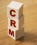 CRM, Customer Relationship Management on wooden blocks. Business concept