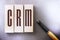 CRM Customer Relationship Marketing written on a wooden blocks. Marketing research concept