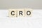 CRO wooden blocks word on grey background. CRO - conversion rate optimization, information concepts