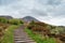 Croagh Patrick, Ireland White statue of Saint Patrick holding green shamrock at the start of foot path to the peak of Croagh