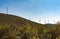 Croatia.Wind turbines standing on a hill against a clear blue sky.