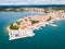 Croatian town of Porec, shore of blue azure turquoise Adriatic Sea, Istrian peninsula, Croatia. Bell tower, red tiled roofs.