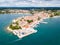 Croatian town of Porec, shore of blue azure turquoise Adriatic Sea, Istrian peninsula, Croatia. Bell tower, red tiled roofs.