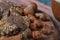 Crocante chocolate cookies with nuts on a wooden board