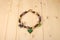 Crochet baby handmade beads with acorns and leaves on a light wo