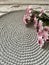 Crochet circle table runner on a wooden table with a Transvaal daisy flowers on top