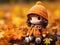 a crochet doll is sitting on a log in the autumn leaves