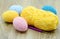 Crochet easter eggs in blue pink yellow on wooden background