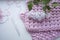 A crochet motif and tools withlilac flowers