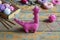 Crochet pink dinosaur. Making toy for child. On table threads, needles, hook, cotton yarn. Handmade crafts. DIY concept. Small