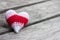 Crochet varicolored heart shape made from yarn on vintage wooden table for Valentine`s day.