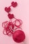 Crocheted amigurumi pink heart with crochet hook and skein of yarn on a pink background. Valentine\\\'s day banner