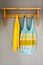 Crocheted Bag and a Yellow Towel Hanging on Wall Rack