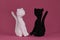 Crocheted black and white kittens, handmade art. Romantic relationships between pets. Amigurumi two cats in love sitting