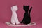 Crocheted black and white kittens, handmade art. Romantic relationships between pets. Amigurumi two cats in love sitting