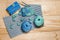 Crocheted blue-green lace napkins and knitting tools, balls of yarn and hooks on wooden background close up with place for your