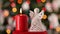Crocheted christmas angel decoration and burning candle