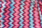 Crocheted dress made of red, pink, blue threads with a zigzag missoni pattern