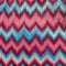 Crocheted dress made of red, pink, blue threads with a zigzag missoni pattern